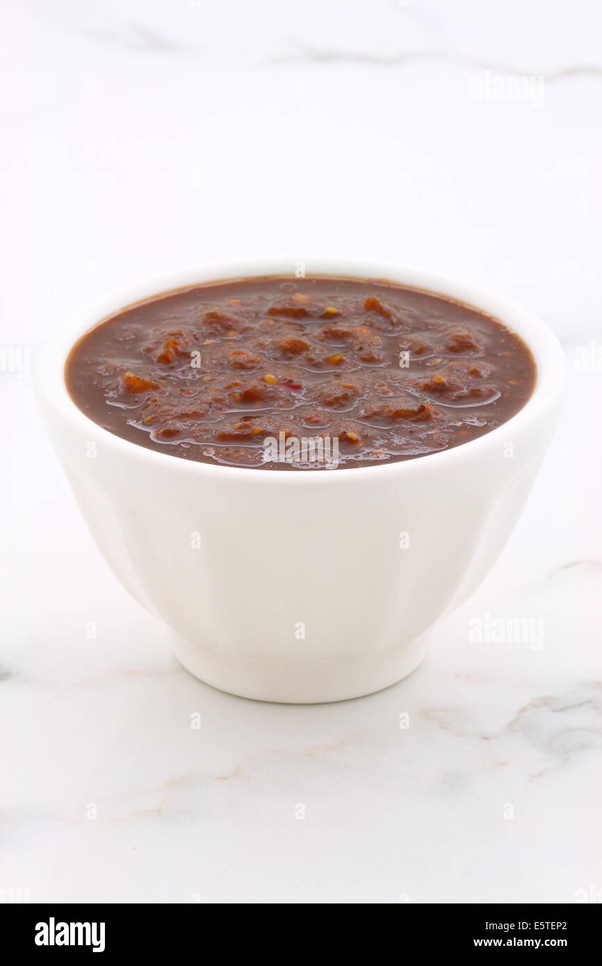 Artisan mexican chipotle sauce on vintage carrara marble table, with a delicious smoky flavor perfect for all your Mexican, tex- Stock Photo