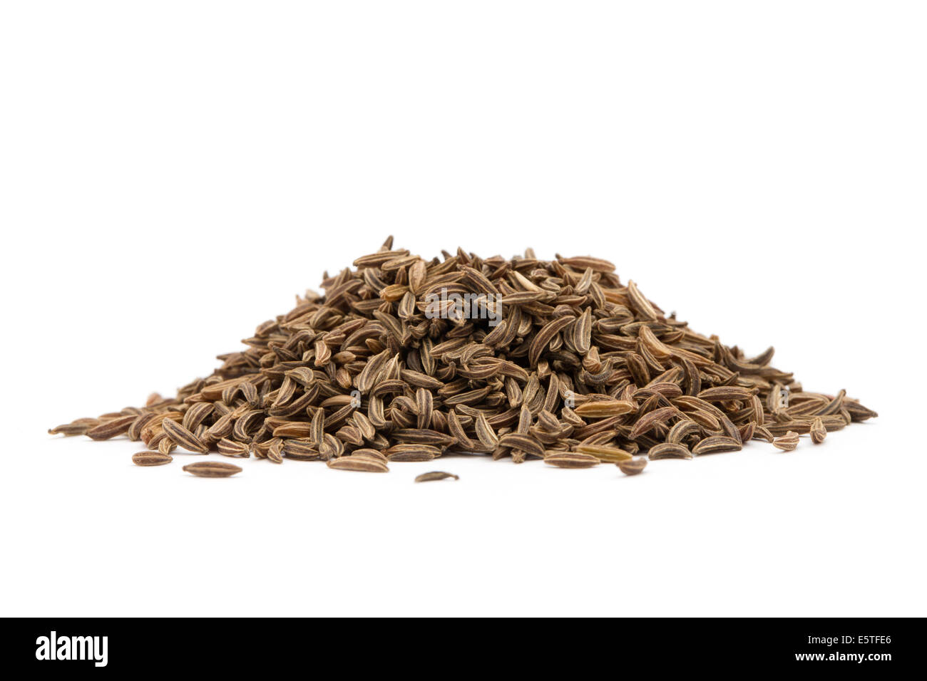 Pile of cumin seeds isolated on white background Stock Photo