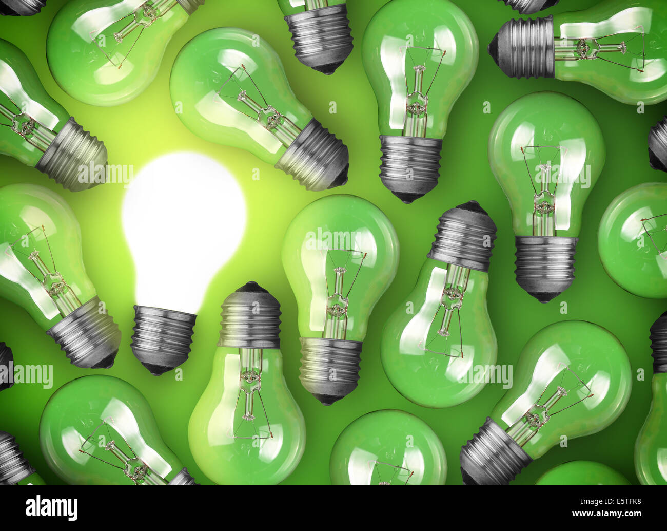 Concept for big idea. Glowing light bulb on green background Stock Photo