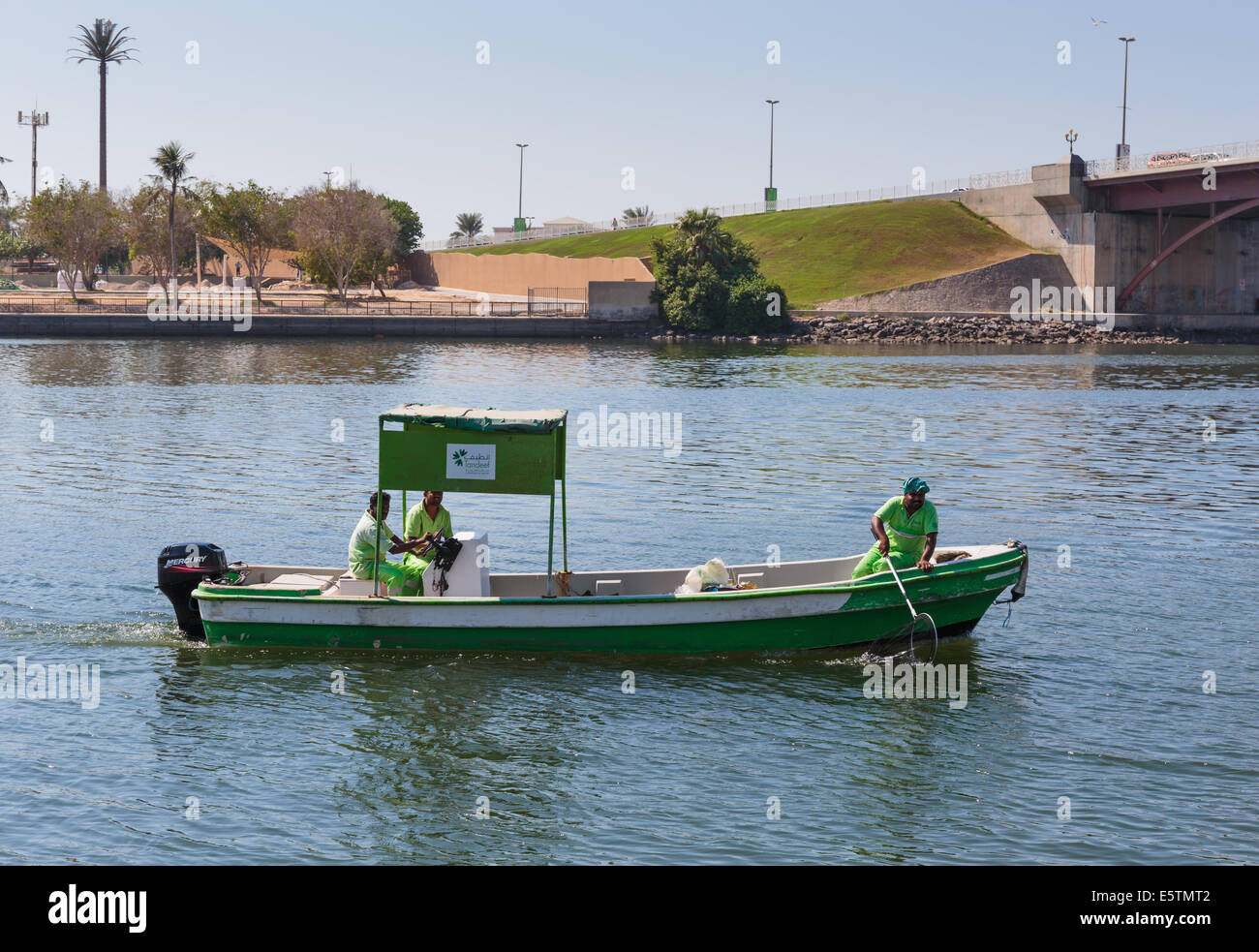 SHARJAH, UAE OCTOBER 28, 2013 Workers in uniform on the boat