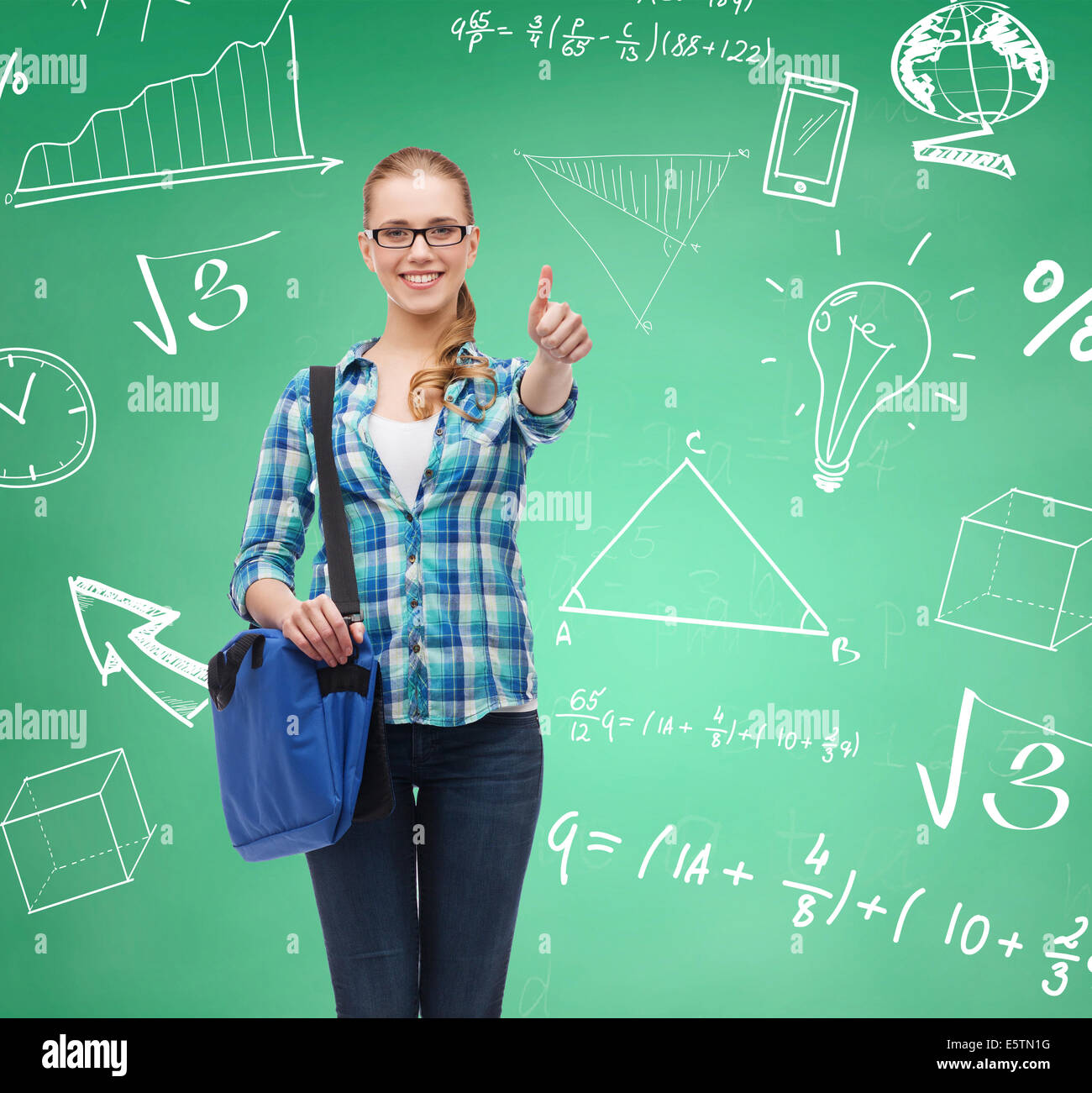 smiling student girl showing thumbs up Stock Photo