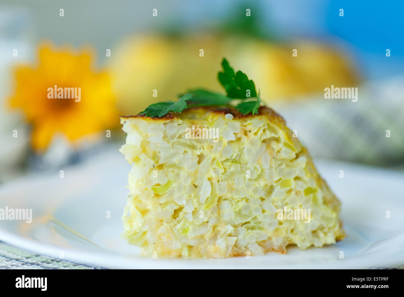 Rice casserole with zucchini and cheese omelet Stock Photo