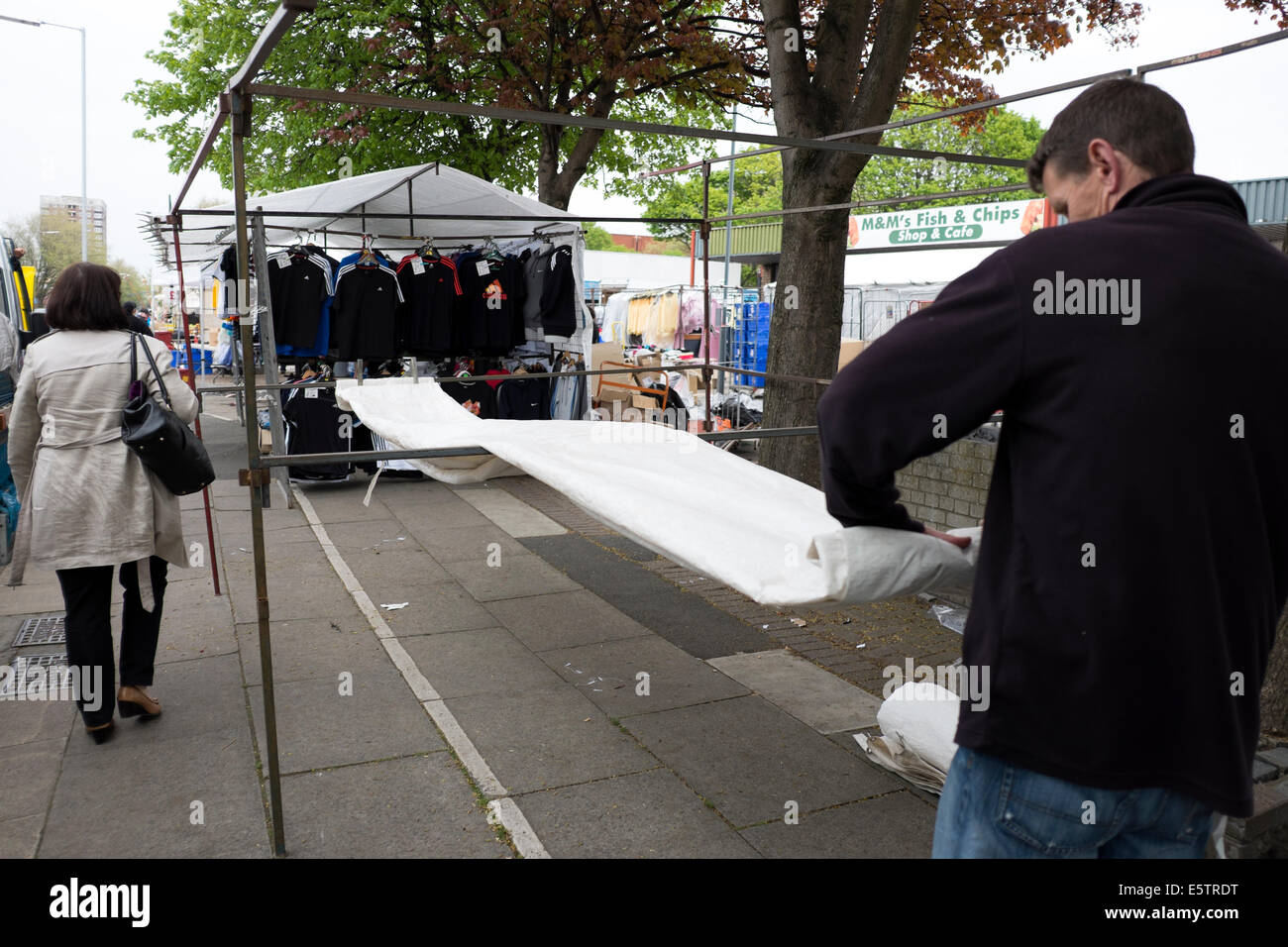 Market Stall holder putting stall away packing up closing Stock Photo