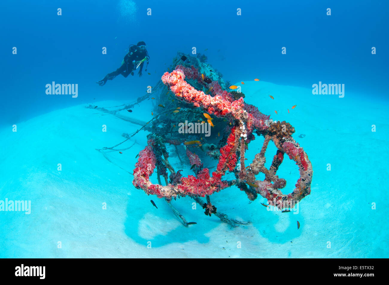 Diver and a small wreck on a sandy sea floor south of Bolifushi island, south Male' Atoll in Maldives Stock Photo