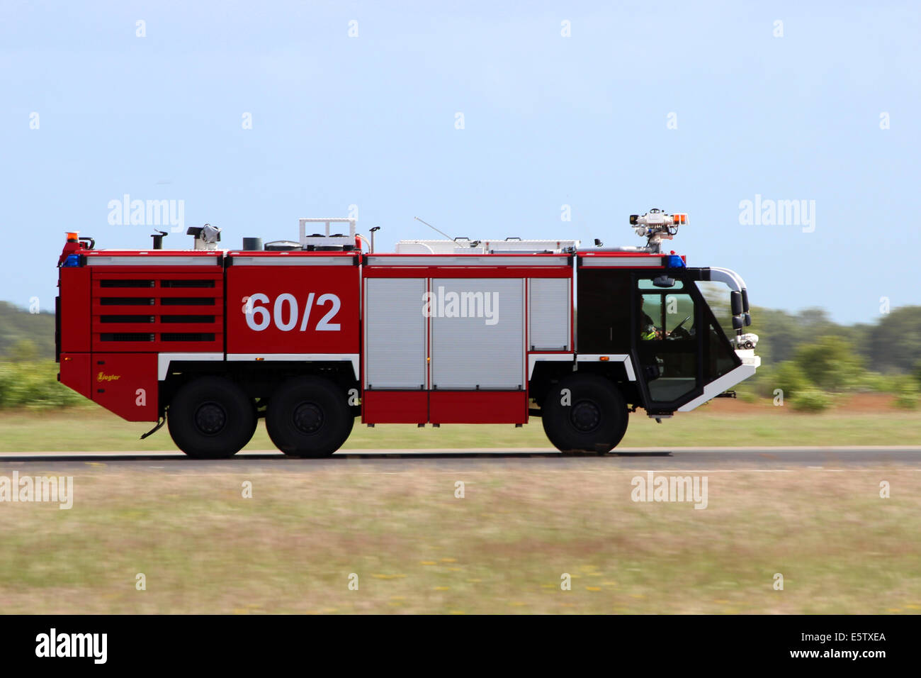 Fast moving Airport firetruck at Wittmund airbase in Germany Stock Photo