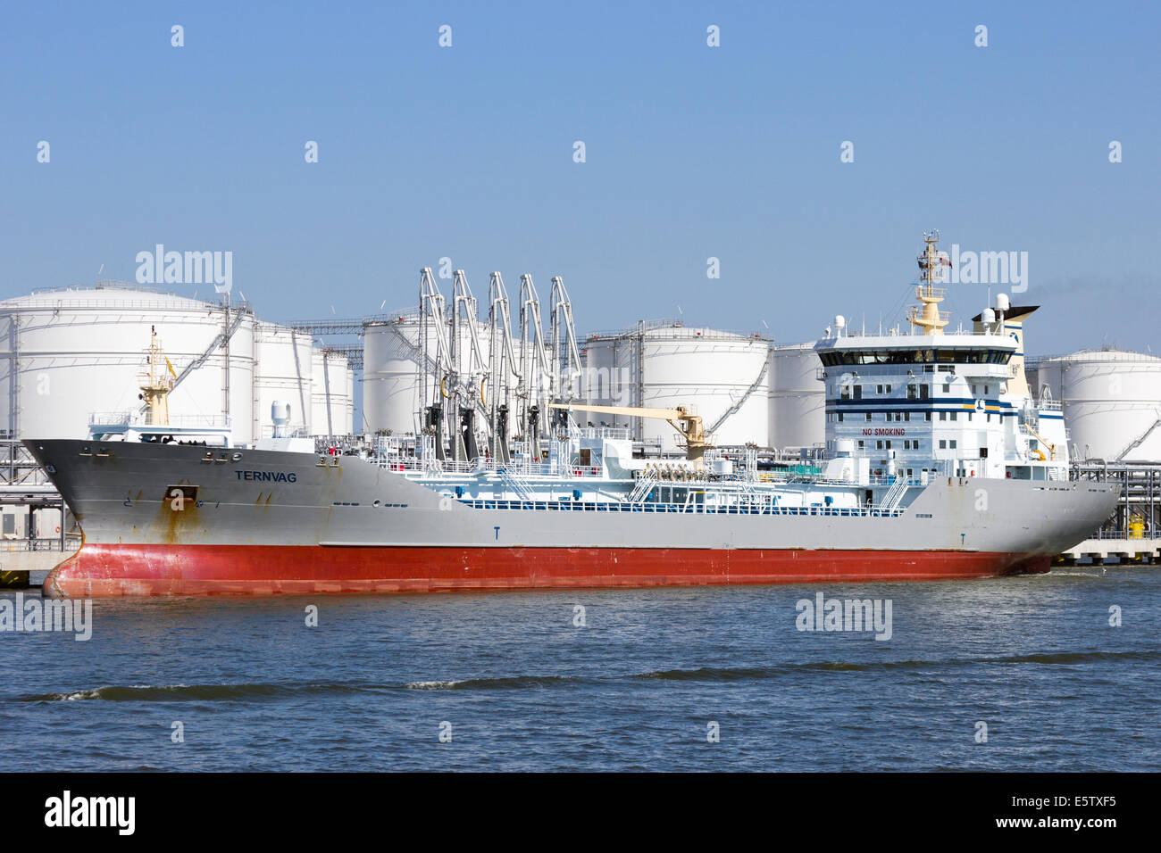 Oil tanker near oil silos in the Port of Antwerp. Stock Photo