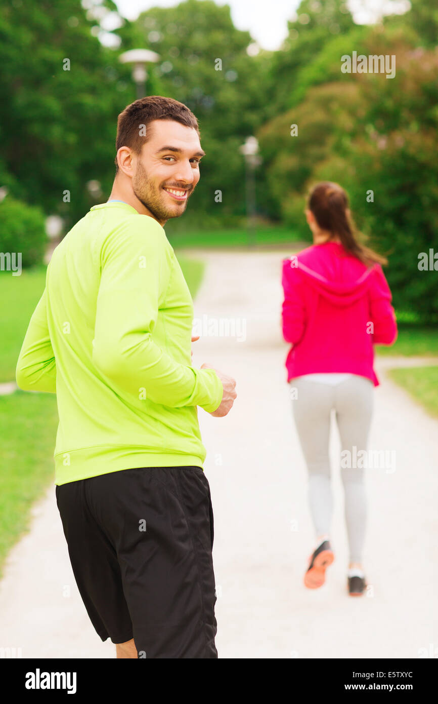 smiling couple running outdoors Stock Photo - Alamy