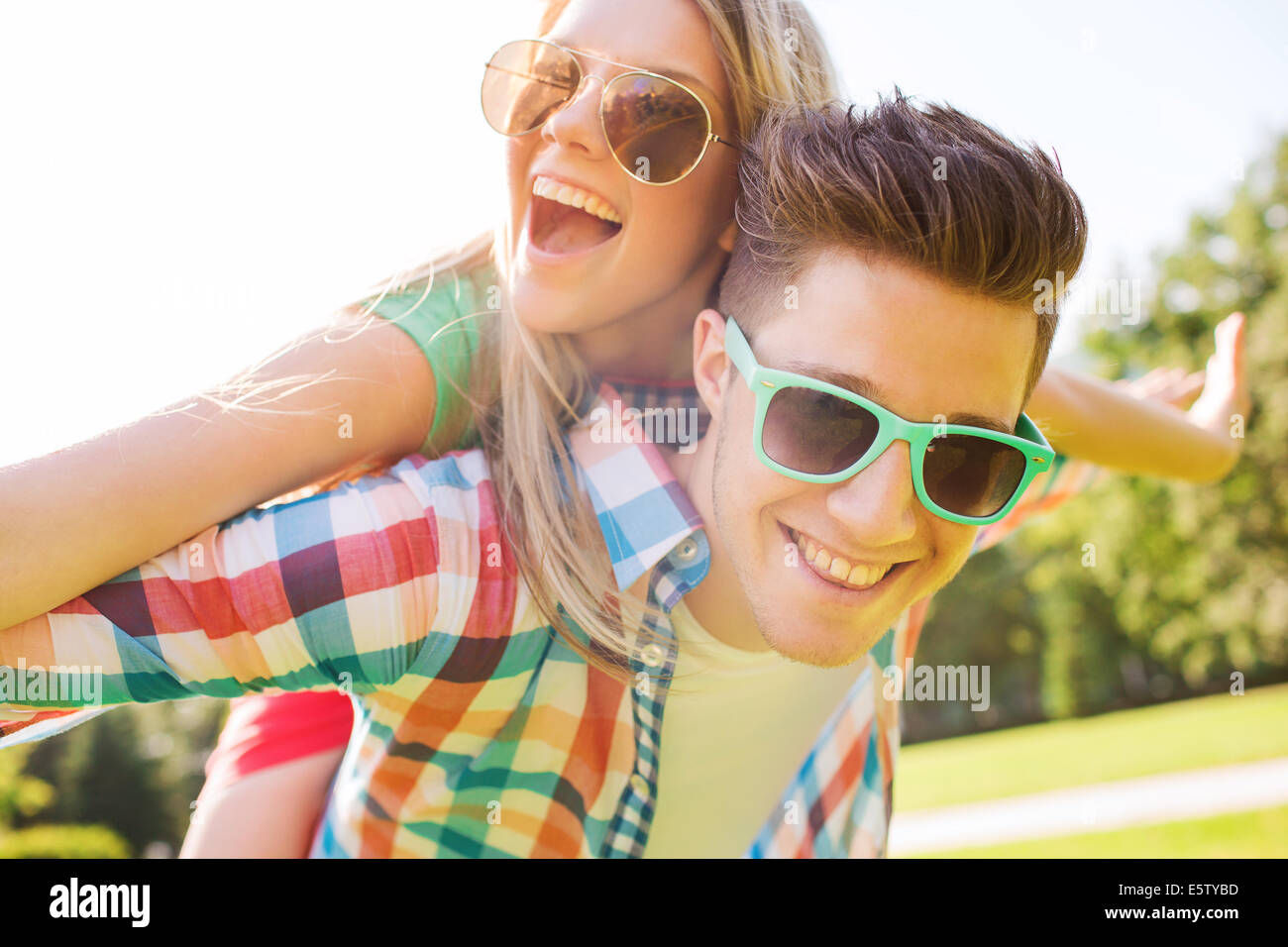 smiling couple having fun in park Stock Photo - Alamy