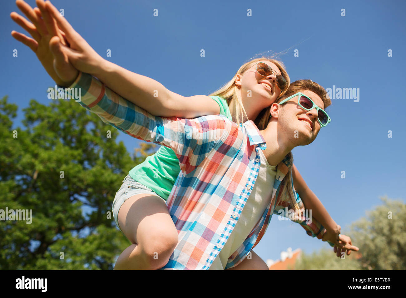 smiling couple having fun in park Stock Photo - Alamy