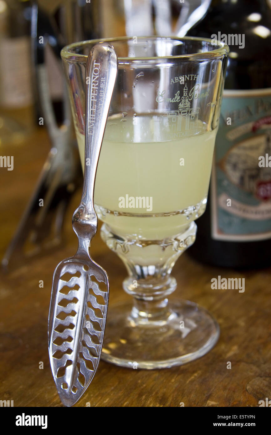 A glass of Absinthe 'green fairy' spirit drink with its special spoon Stock Photo