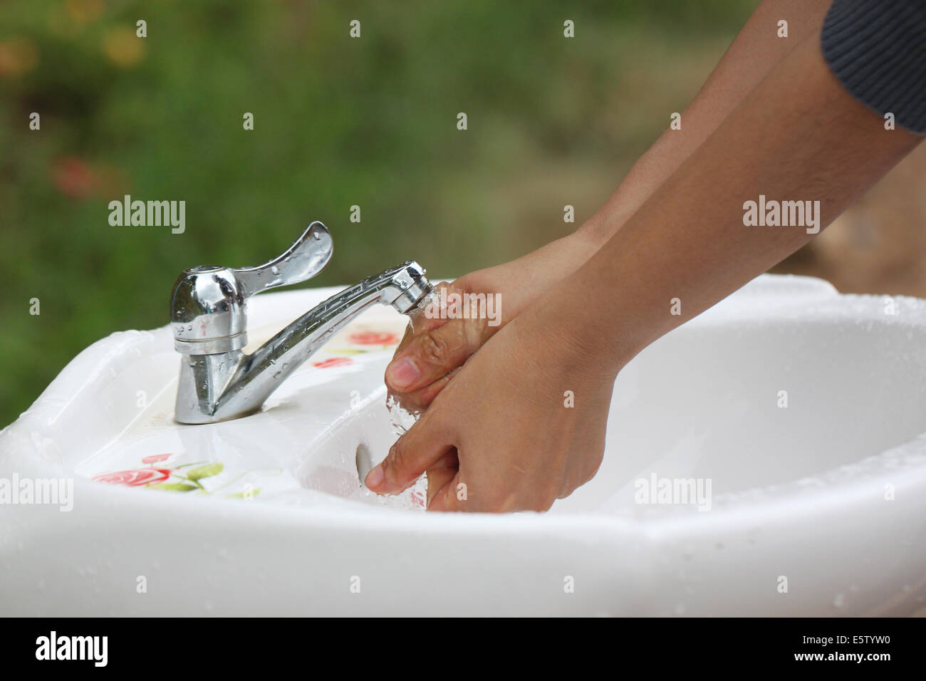 Women's hands are washed clean of faucets. Stock Photo