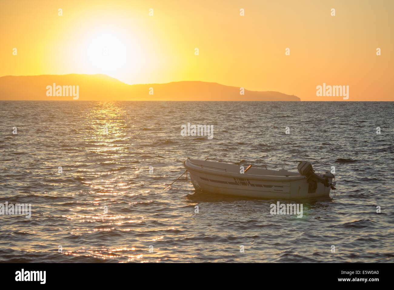 sun sunset sea ocean rowboat boat island Stock Photo