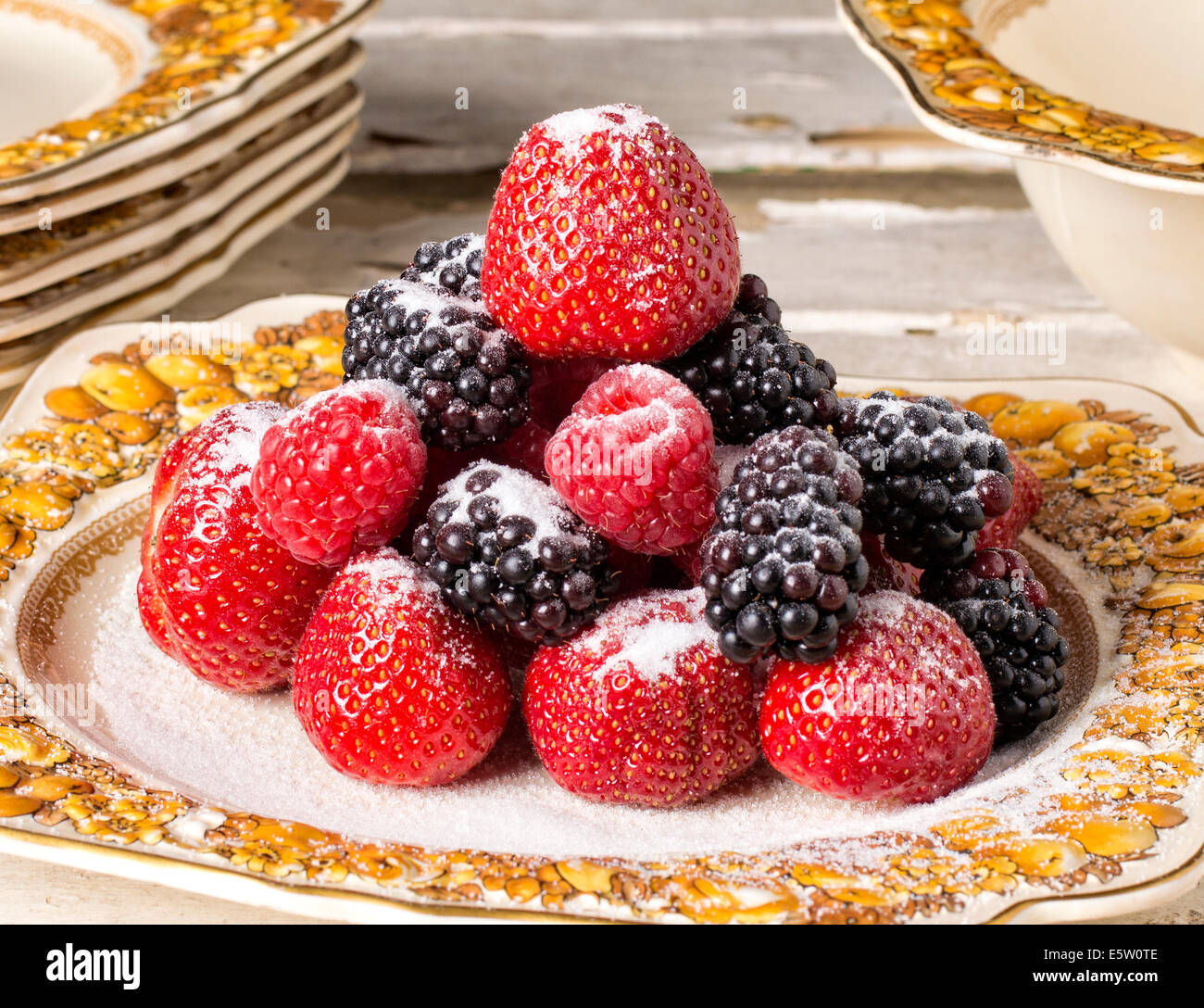 Summer fruits - strawberries and blackberries with a sprinkling of sugar Stock Photo
