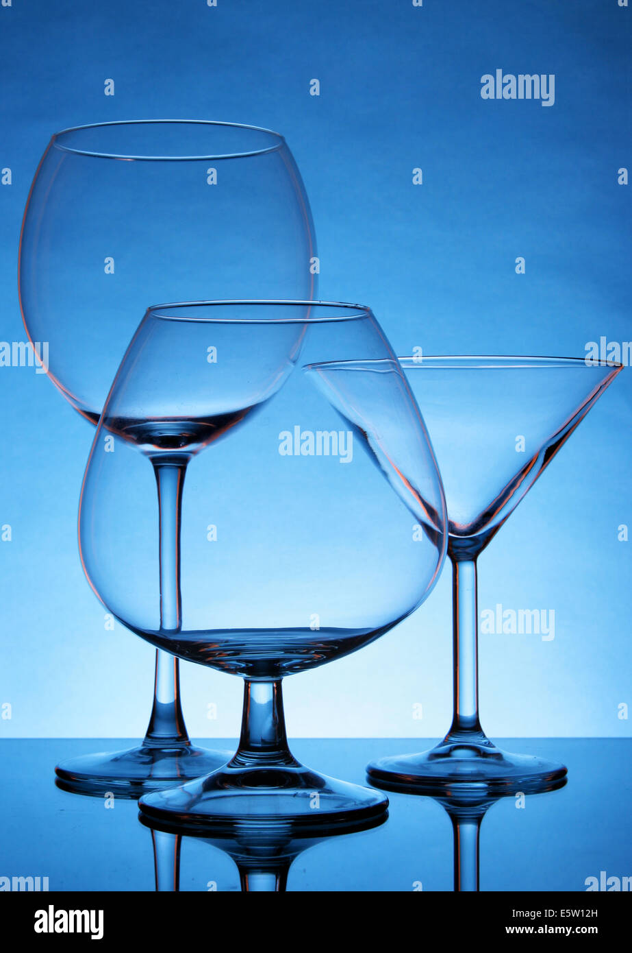 Still-life with empty glasses over blue background Stock Photo
