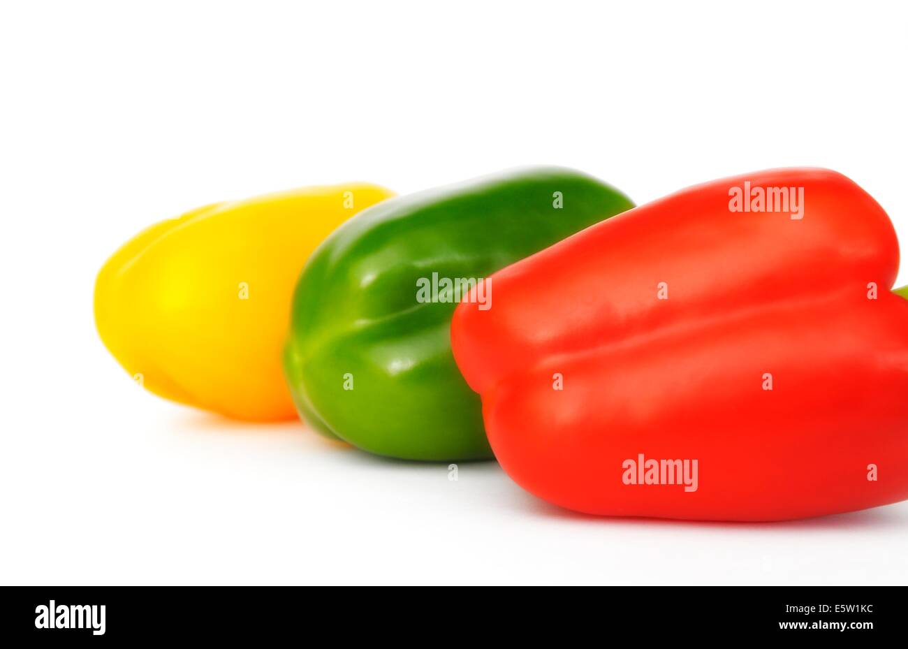 A red yellow and green pepper on a white background Stock Photo - Alamy