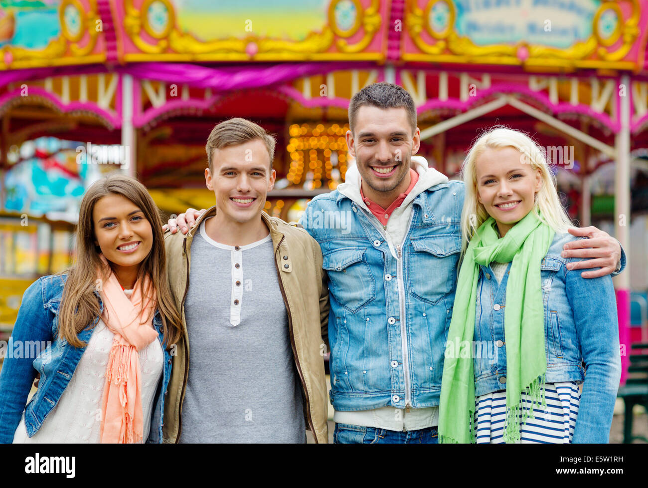 group of smiling friends in amusement park Stock Photo - Alamy