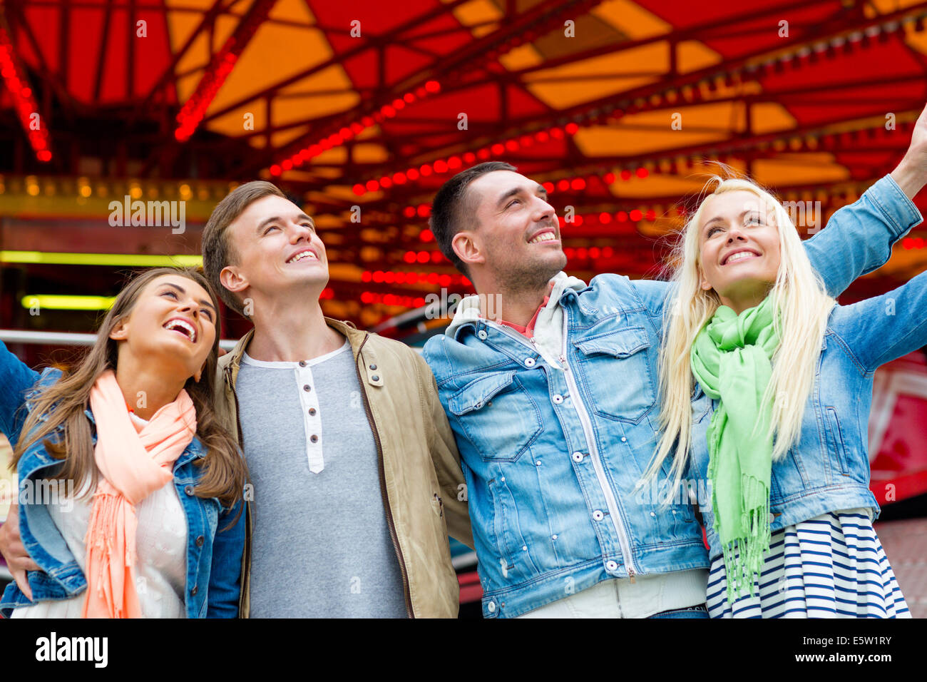 group of smiling friends in amusement park Stock Photo - Alamy