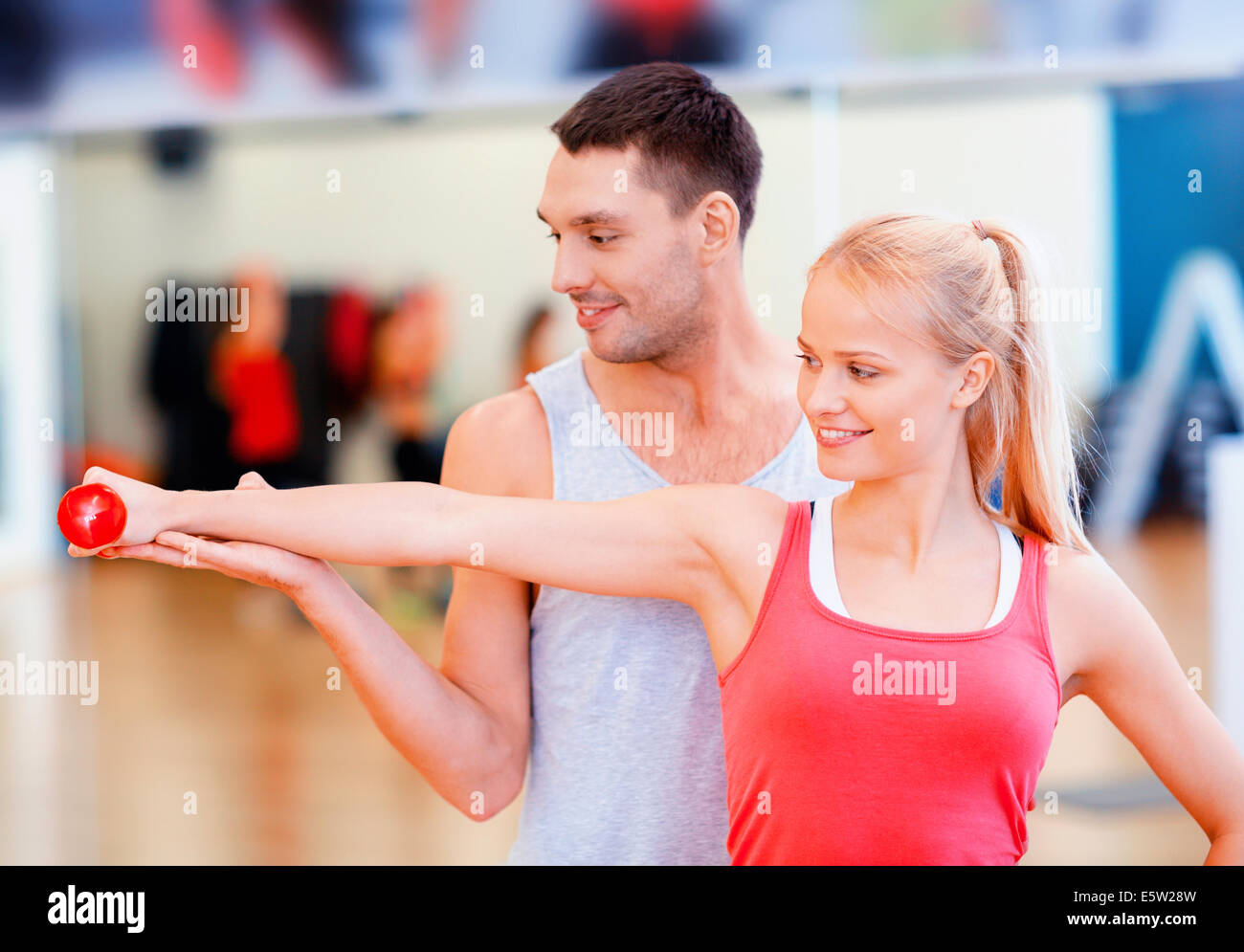 male trainer with woman working out with dumbbell Stock Photo - Alamy