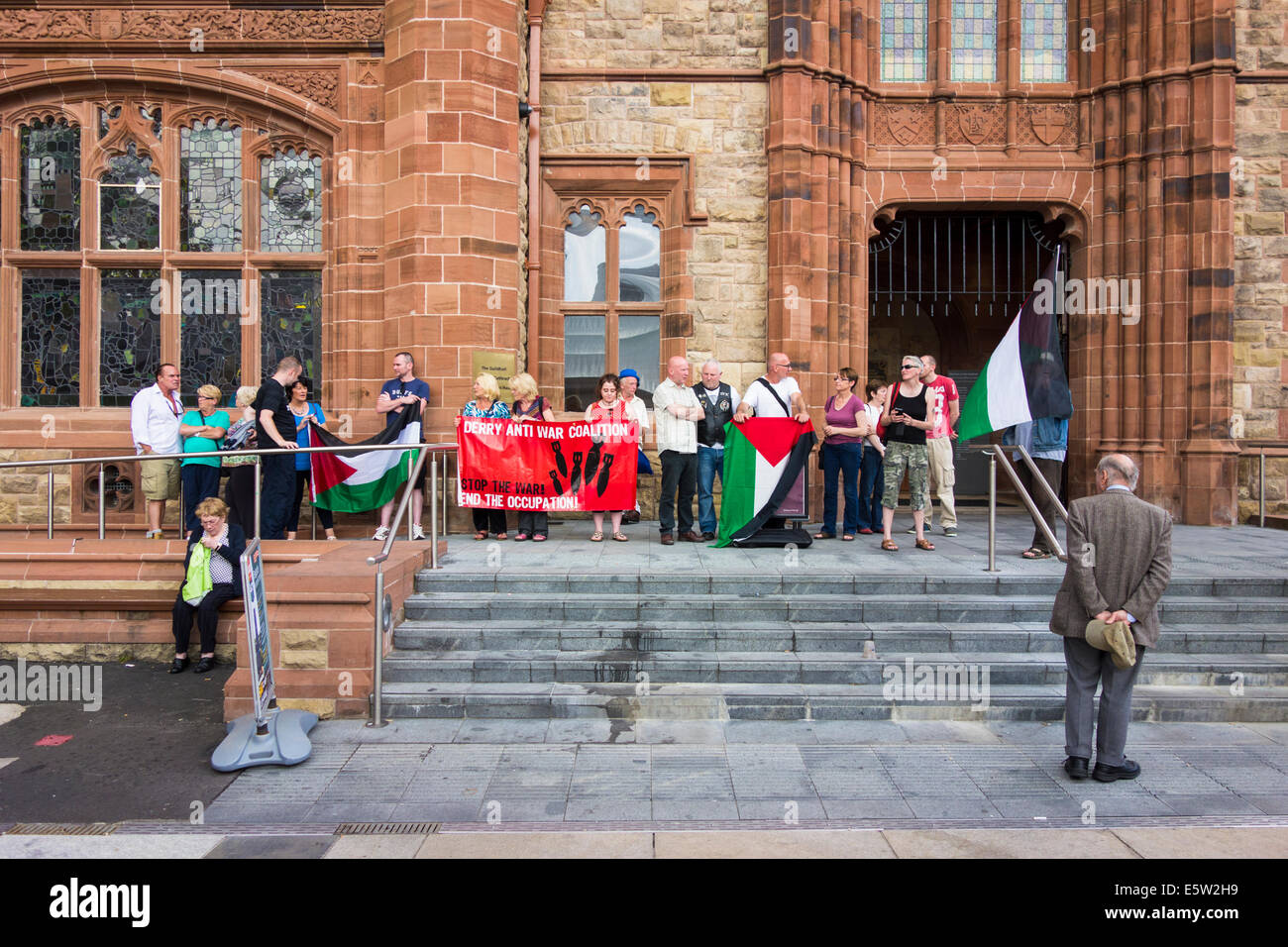 Group of people from the Derry Anti War Coalition protest outside the Guildhall against the occupation of Palestine Stock Photo