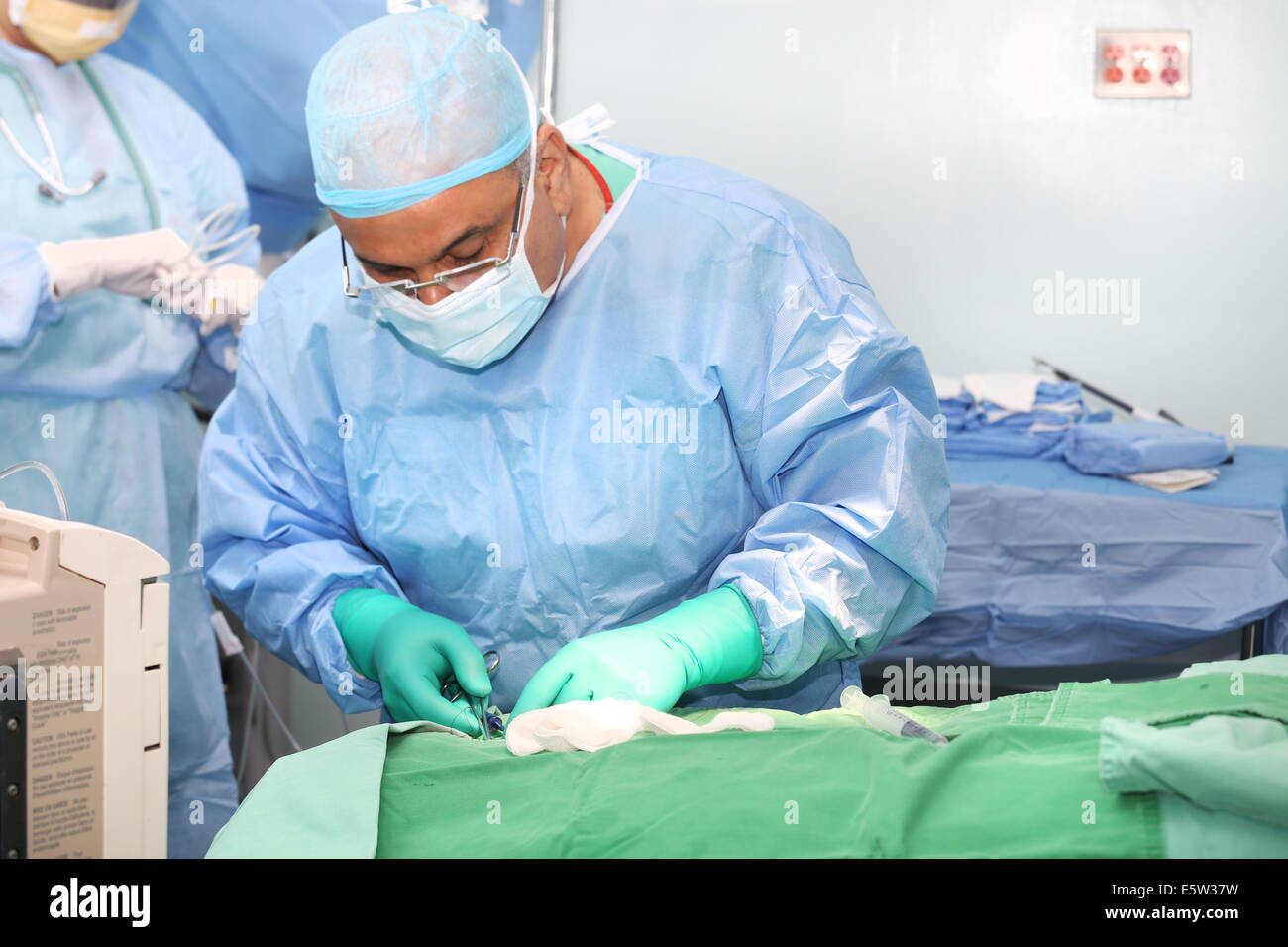 Doctor using tools in a surgery Stock Photo Alamy