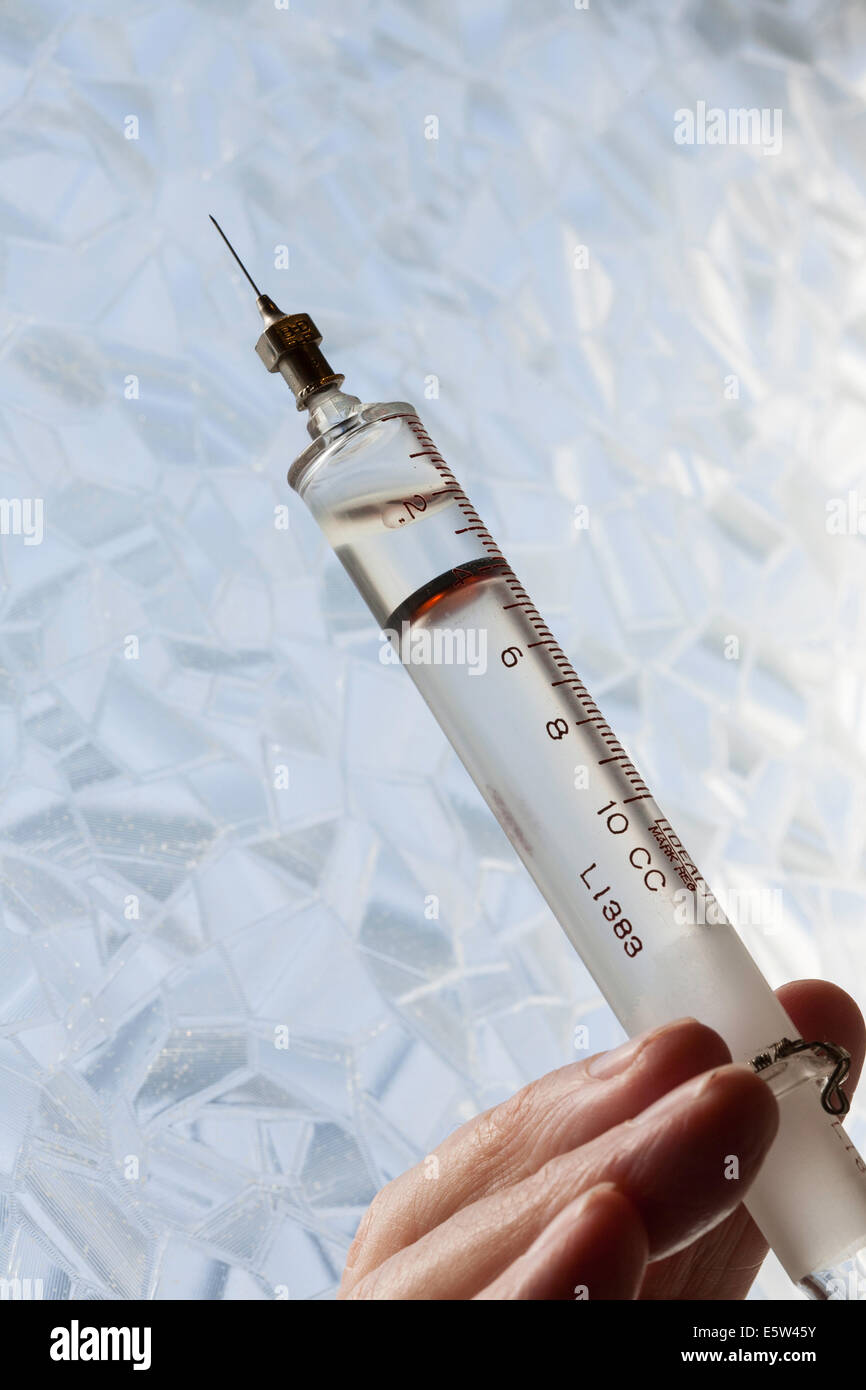 Antique Glass and Steel Syringe Close Up Stock Photo
