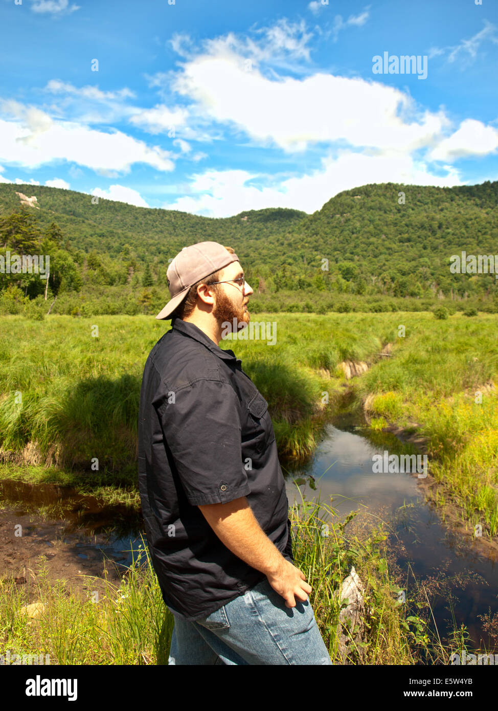 young man admiring the landscape at Lewey Lake in the Adirondack State park Stock Photo
