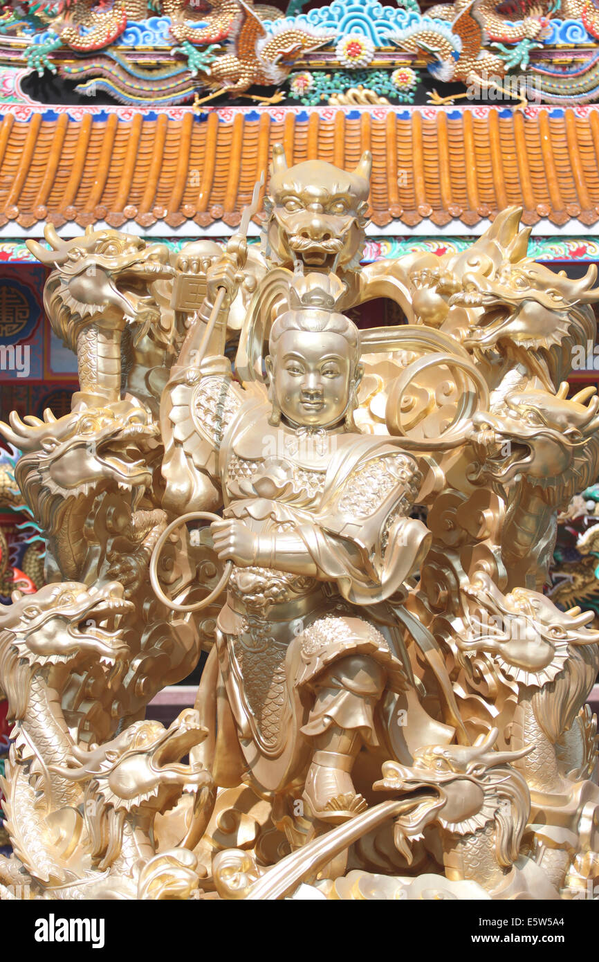 gold sculpture of deity in the Chinese temple,Thailand. Stock Photo