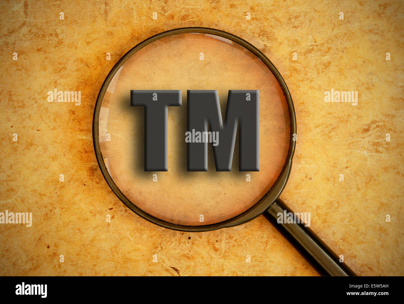 Magnifying glass focusing on trademark sign Stock Photo
