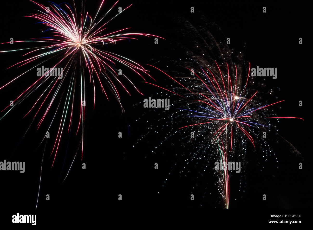 Beautiful multi-colored fireworks exploding in the night sky. Stock Photo