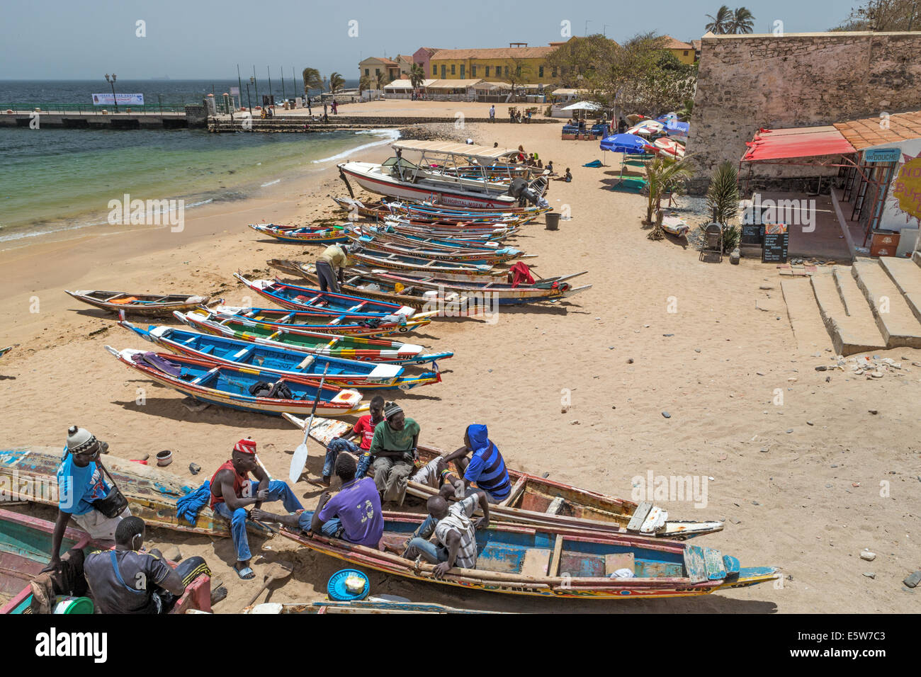 Fishermen relaxing by their boats, Goree Island, UNESCO site, off Dakar, Senegal Stock Photo