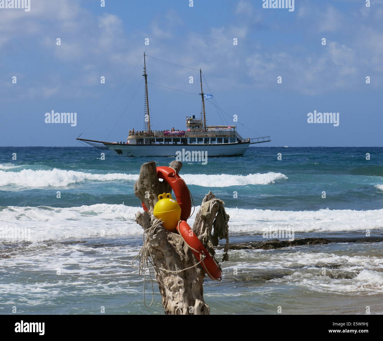 Image of a day cruise boat struggling to enter harbor in rough seas. Stock Photo