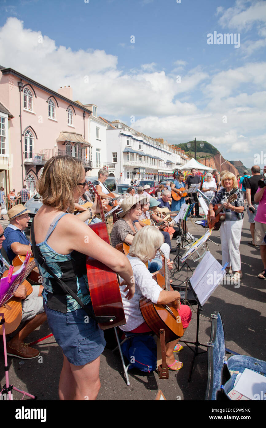 Sidmouth, Devon, UK. 6th Aug, 2014. Music and Dance at the annual Sidmouth Folk Week. Exeter Guitar Groups massed guitar playing entertain visitors on Sidmouth promenade. Credit:  Anthony Collins/Alamy Live News Stock Photo