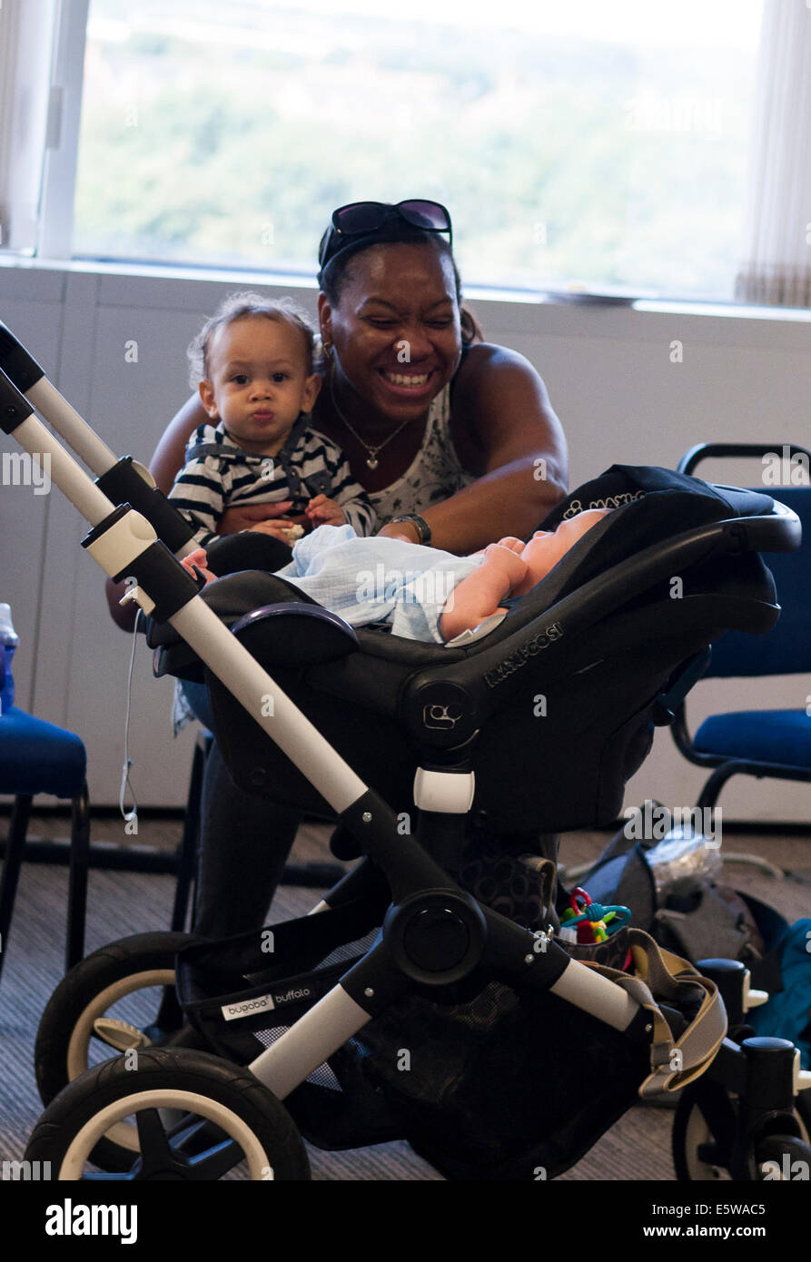 Milton Keynes, UK, 6th Aug 2014. A mother with her children at the