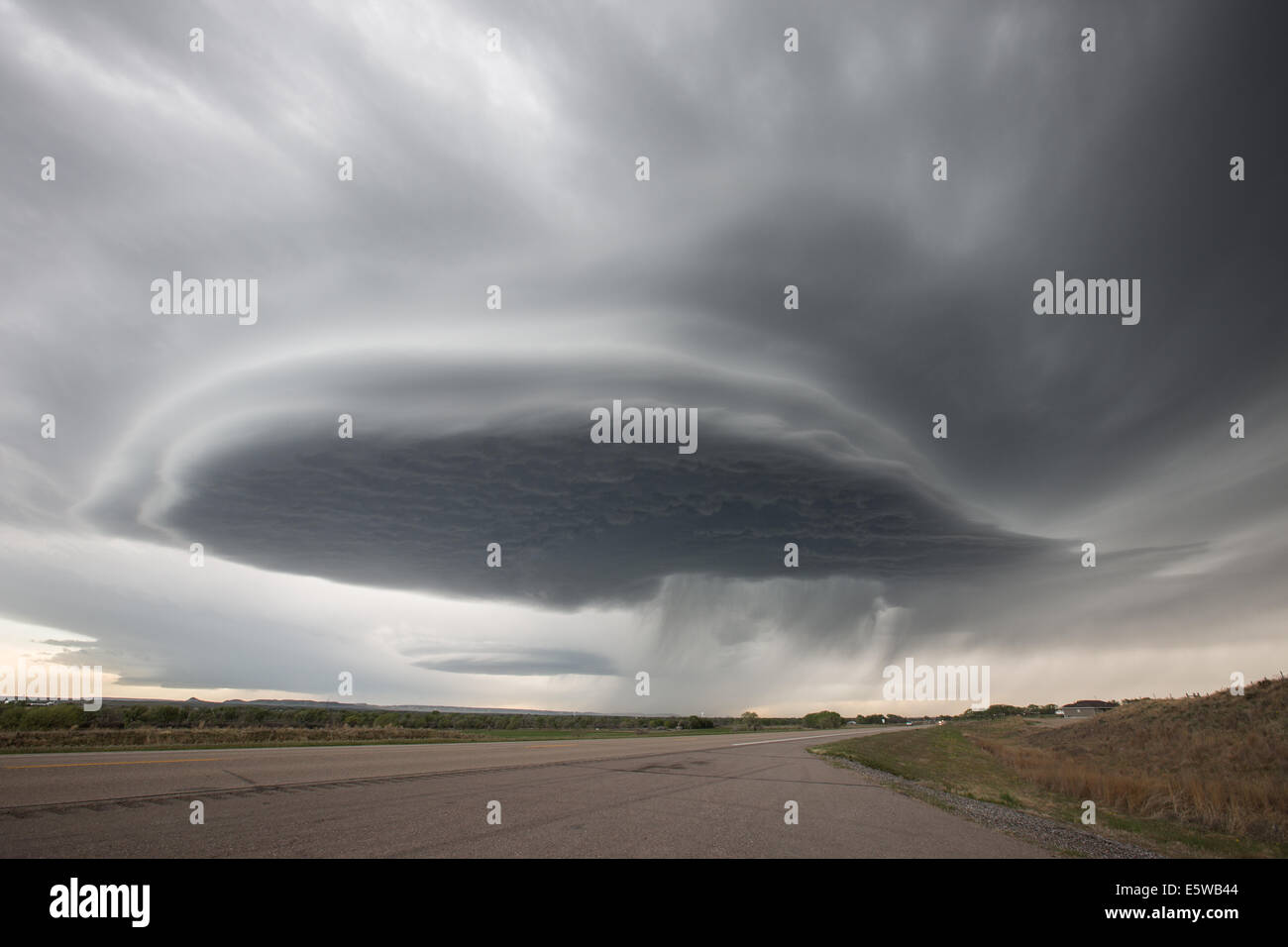 A classic high plains low precipitation supercell thunderstorm taking on a mothership striated appearance with hail fall streaks Stock Photo