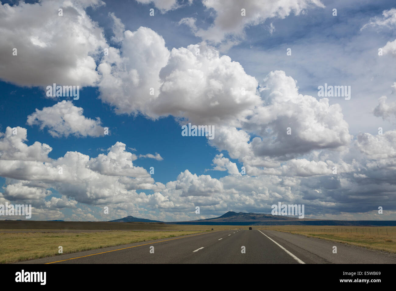 The beautiful arid and diverse desert landscape of New Mexico with mountains, hills, plains and lonely roads. Stock Photo
