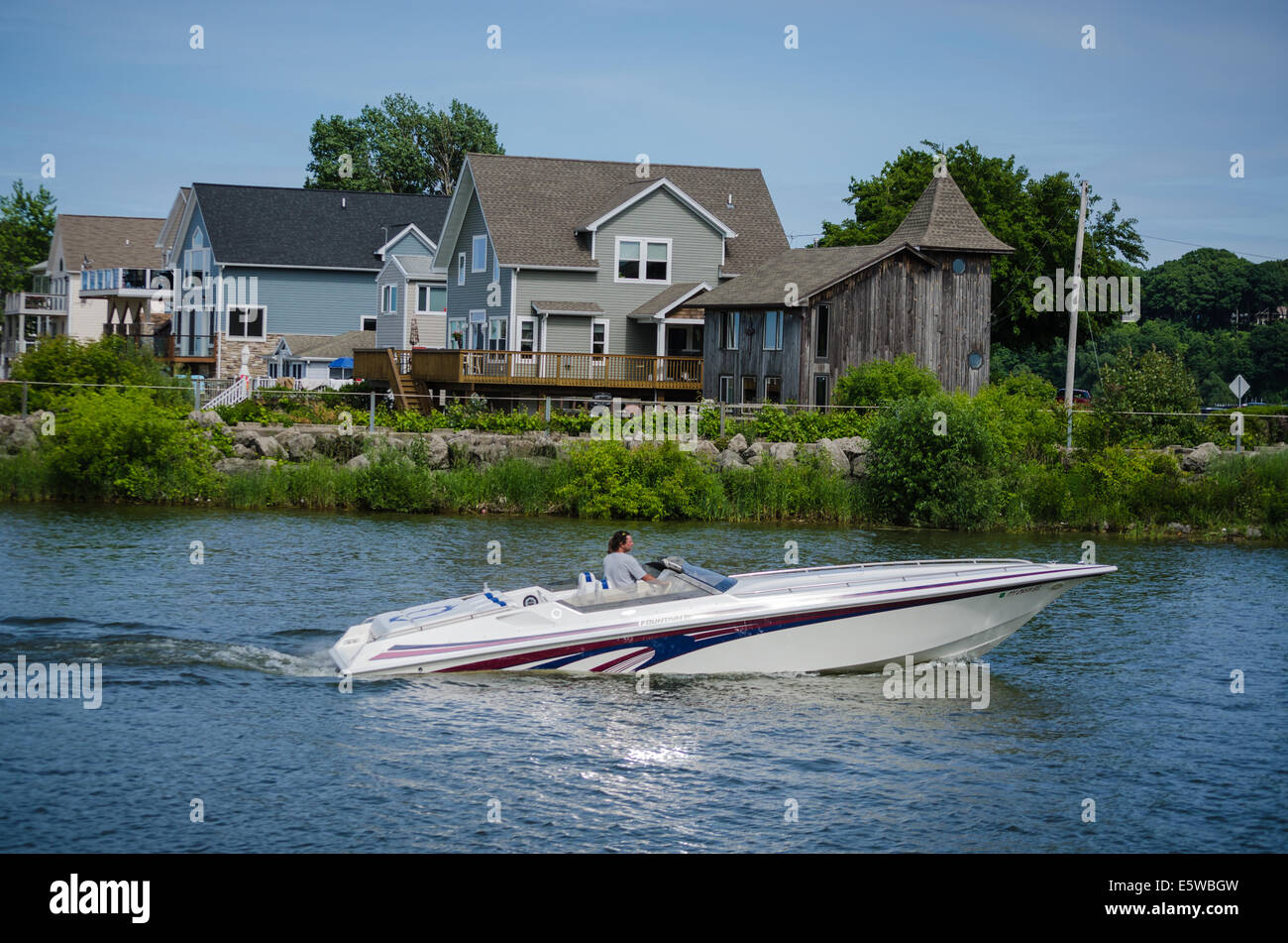 Moter boats enter Irondequoit Bay through breakwater. Stock Photo