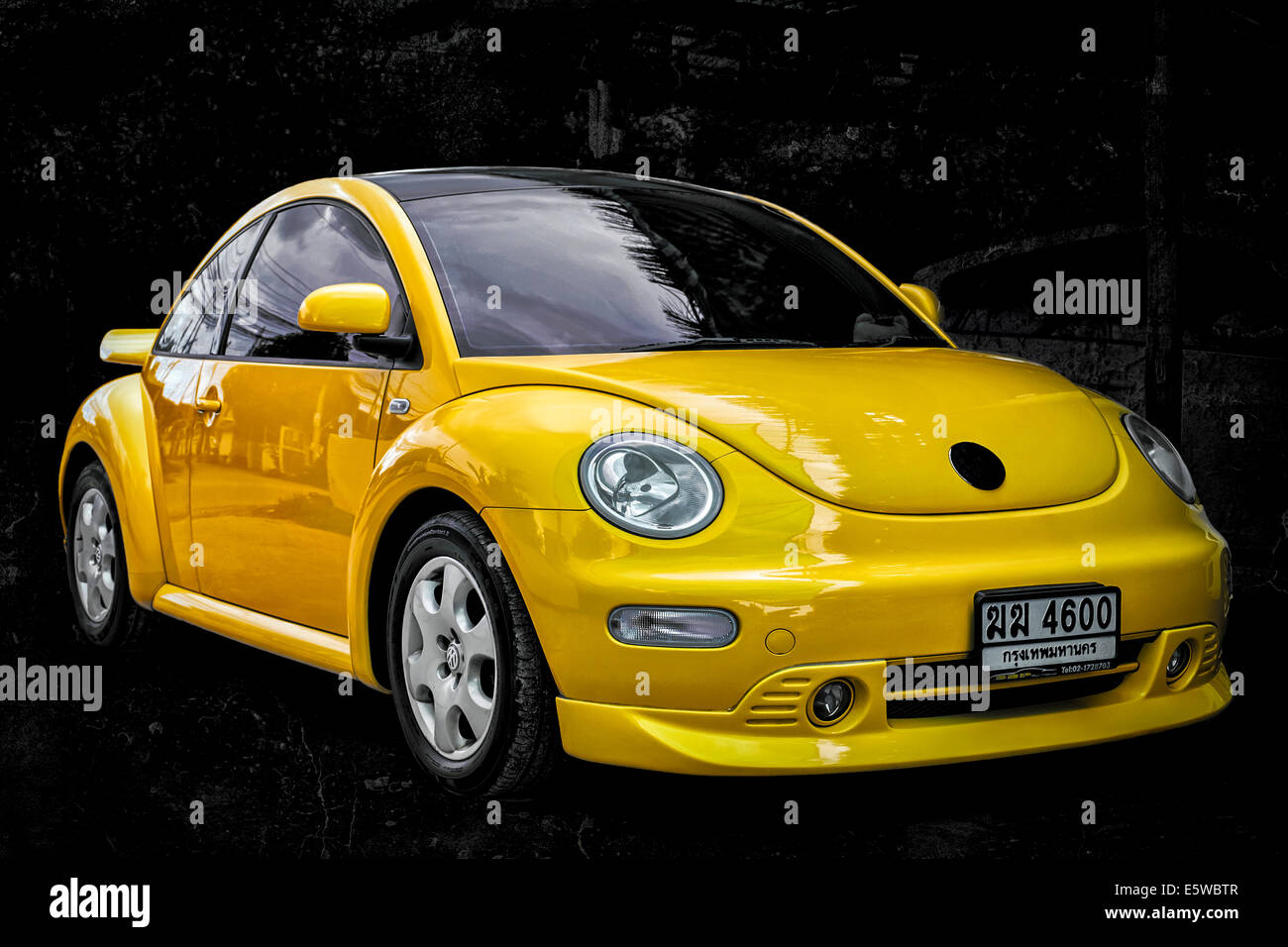 Volkswagen beetle. Vivid yellow modern VW Beetle motorcar against a black  background. Thailand S. E. Asia Stock Photo - Alamy