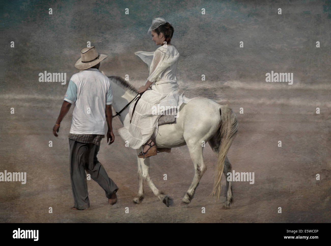 Woman beach horse. Painterly and canvas textured image of female wearing a white lace dress and riding a white horse on the beach Stock Photo