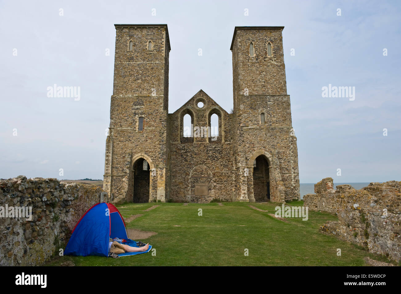 Campers at the ruined church of St Mary dating from the 7th century the towers were added in the 12th century Reculver Herne Bay Kent England UK Stock Photo