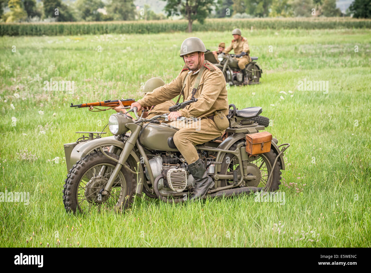 STARY TEKOV, SLOVAKIA - JULY 26,2014:  Soviet soldiers riding sidecars to attack germans during reenactment of World War II Stock Photo