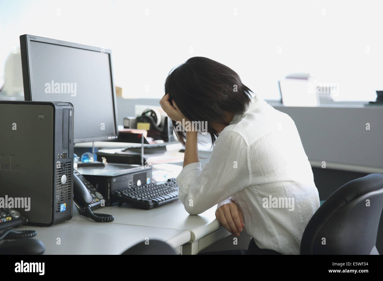Japanese Young Businesswoman Depressed At Her Office Desk Stock