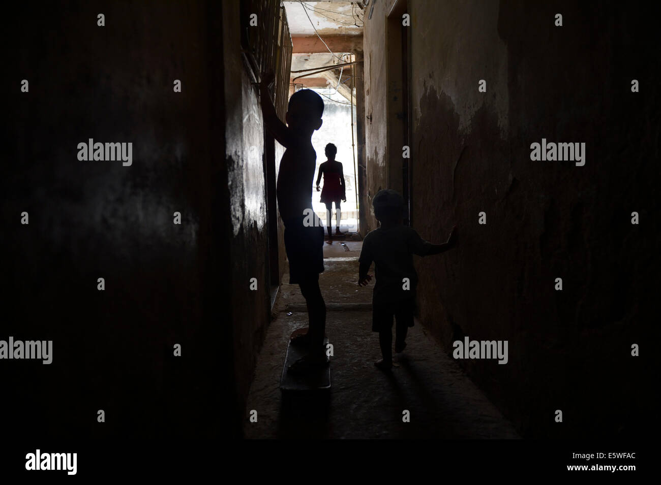 Children playing in the hallway of a squat or occupied house, Gloria district, Rio de Janeiro, Rio de Janeiro State, Brazil Stock Photo