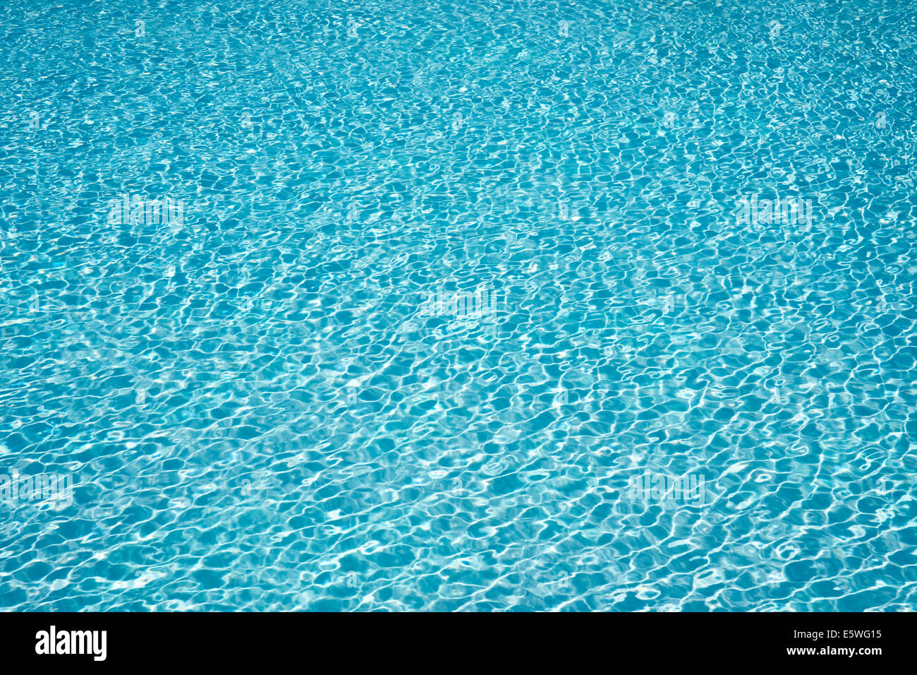 Slightly choppy water surface of a swimming pool Stock Photo