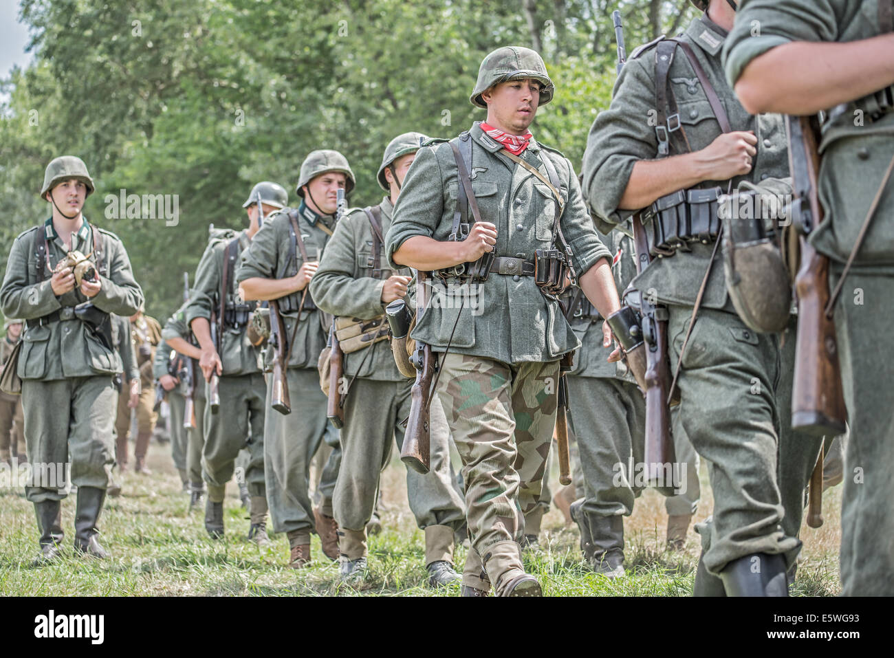 German soldiers marching on battlefield during reenactment of World War II fight Stock Photo