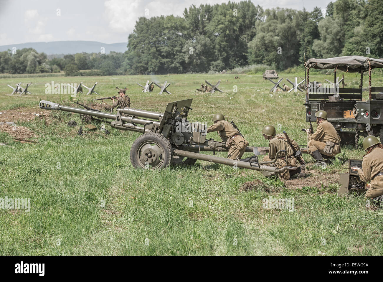 STARY TEKOV, SLOVAKIA - JULY 26,2014:  Soviet soldiers using a cannon during reenactment of World War II fight Stock Photo