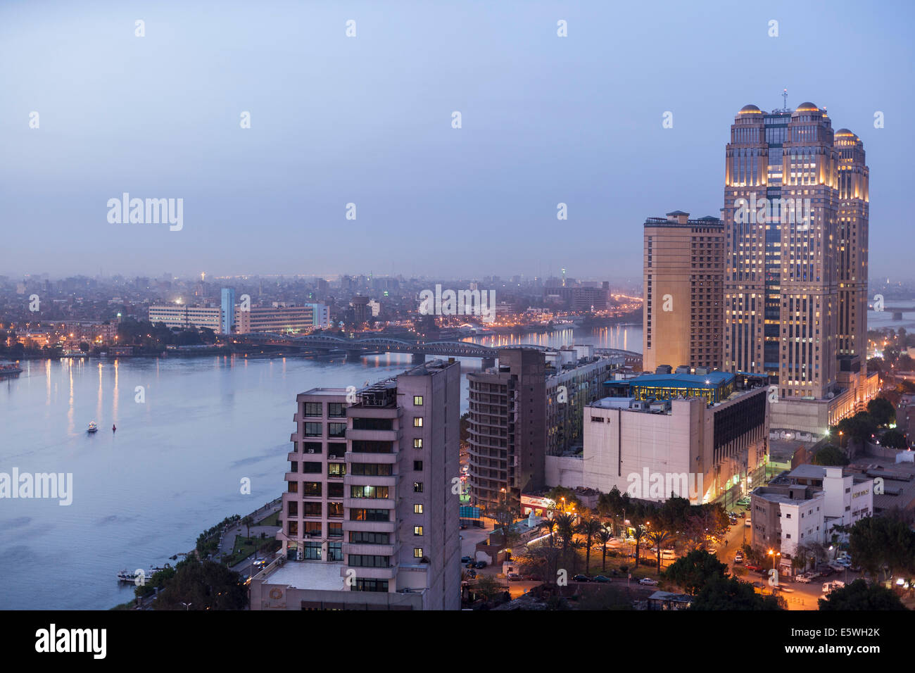 Nile River at dusk in Cairo, Egypt - with the Fairmont Nile City Hotel building on the waterfront Stock Photo