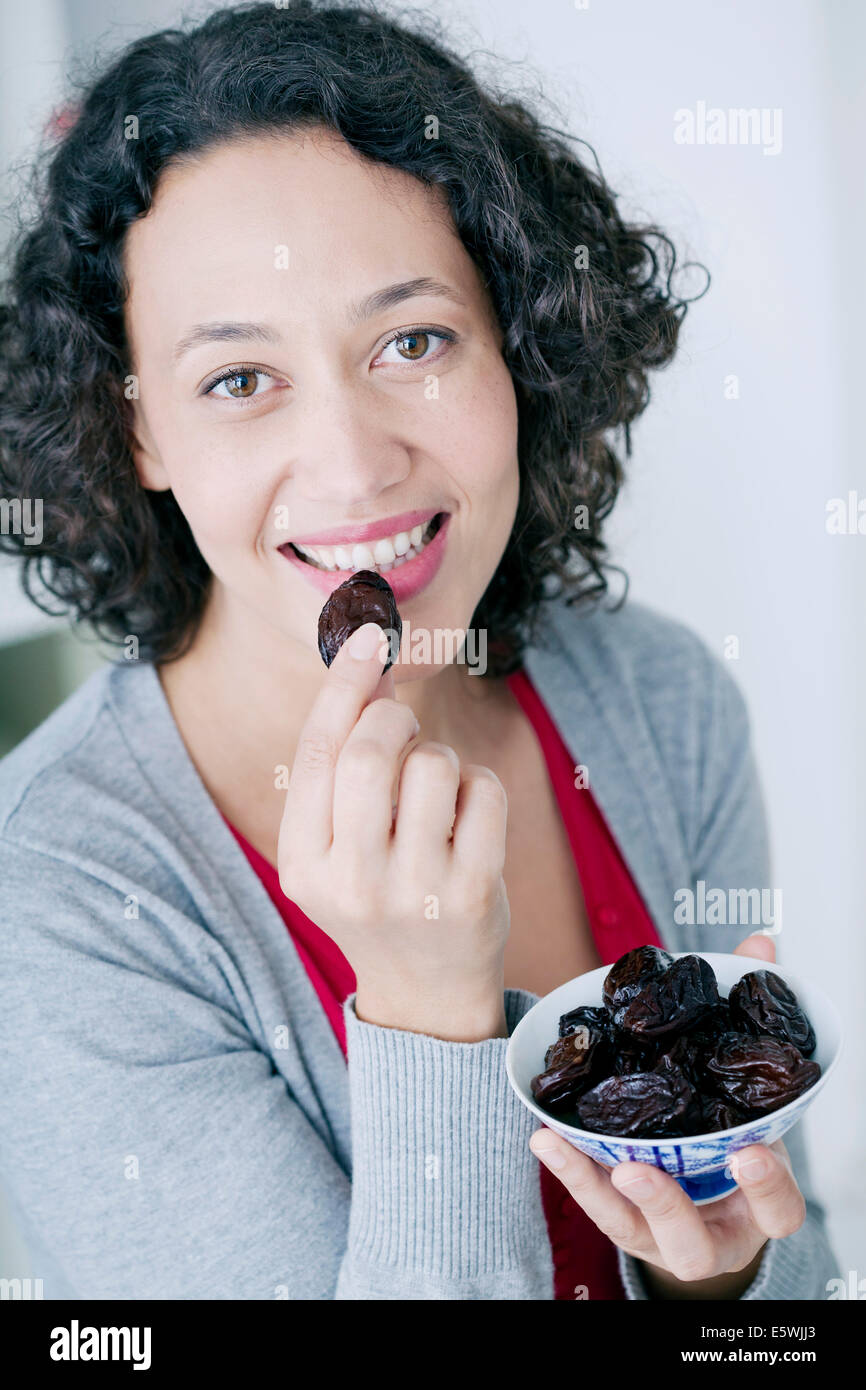 Woman eating dried fruit Stock Photo Alamy