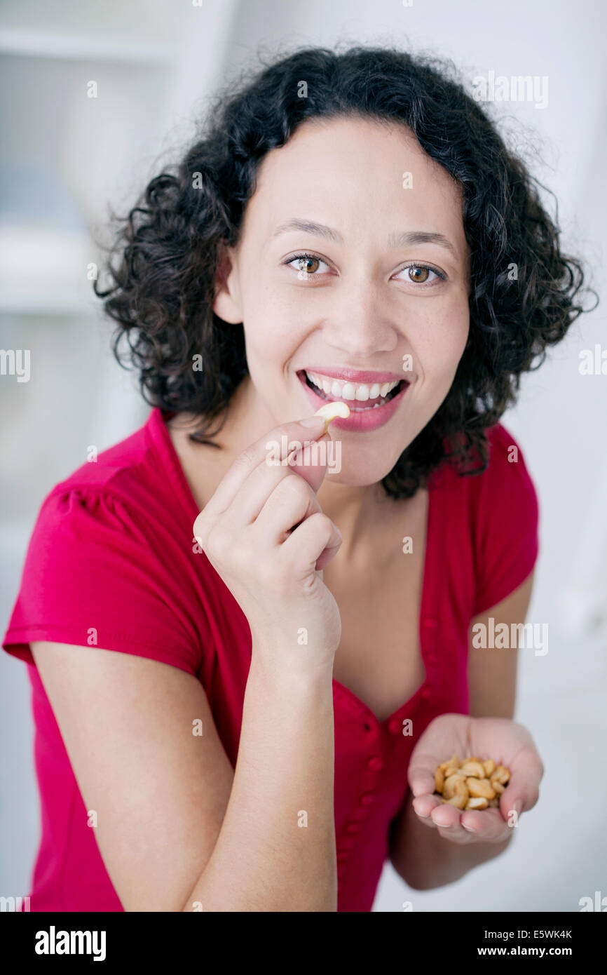 Woman eating dried fruit Stock Photo Alamy