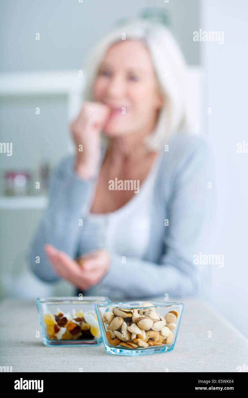 Elderly person eating dried fruit Stock Photo