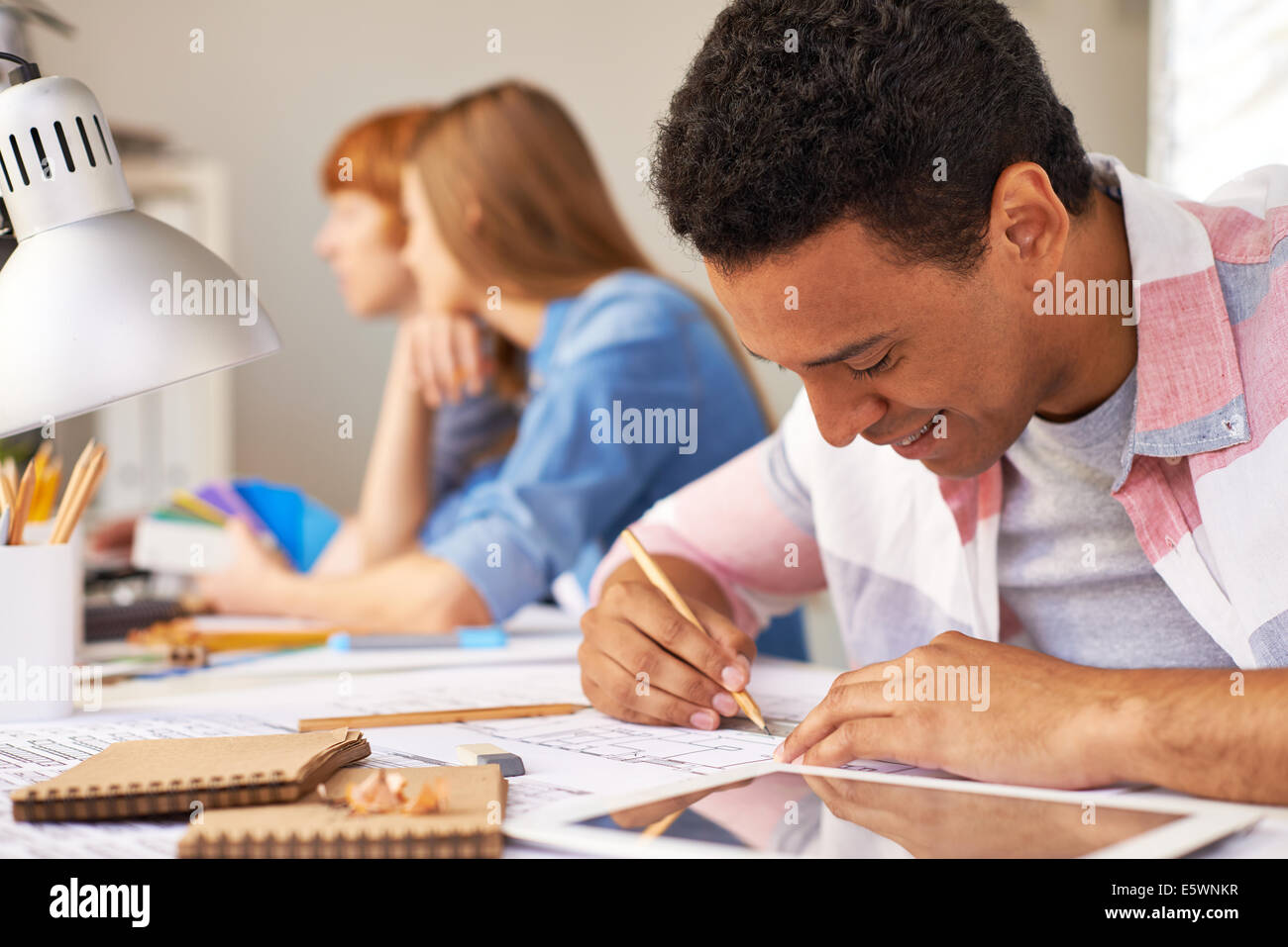 Portrait of smart guy making sketch at lesson Stock Photo